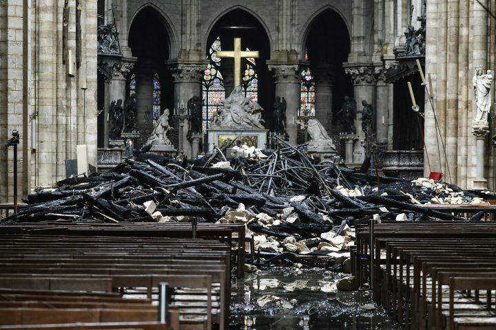 A picture taken on April 16, 2019, shows the altar surrounded by charred debris inside the Notre-Dame Cathedral in Paris in the aftermath of a fire that devastated the cathedral.