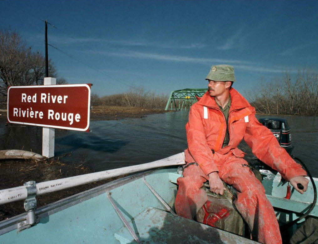 WINNIPEG, CANADA: Canadian Army Master Sgt. Joe Bisson patrols the flooded Red River on April 27, looking for residents needing help in St. Jean Baptise, north of the U.S. border.