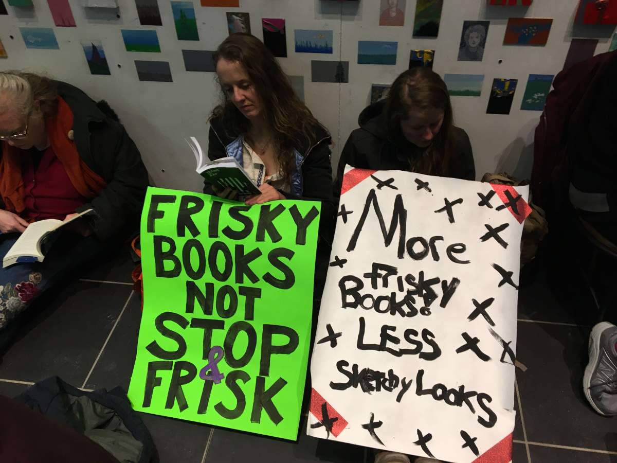Two protesters outside the main entrance of the Millennium Library.
