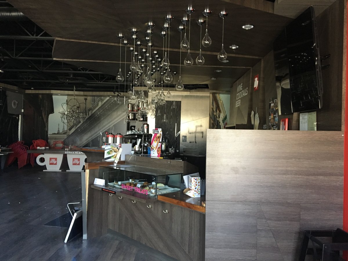 A photo from the inside of the cafe shows a swastika painted on the far wall.