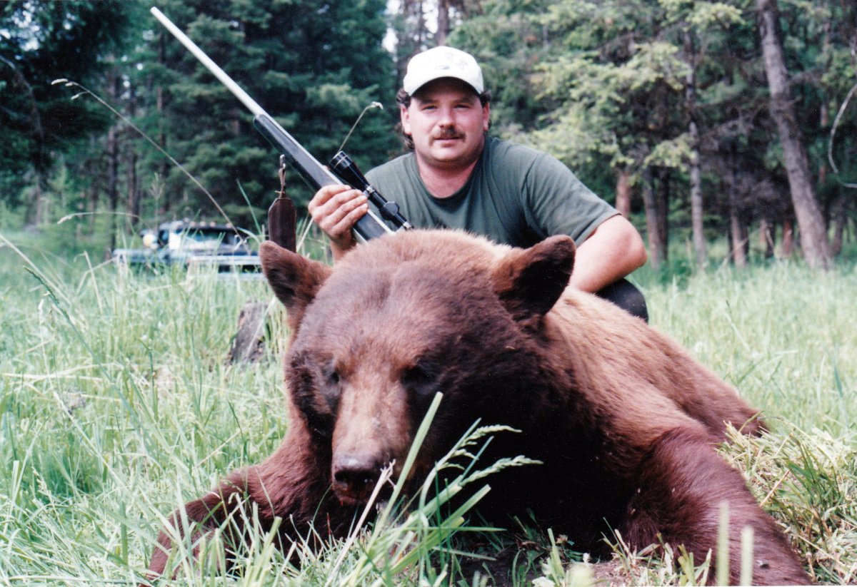 Oliver, B.C., guide outfitter James Wiens is pictured on his website with a bear from a previous hunt. On Monday, Wiens was fined for baiting a black bear with pet food and cooking grease. 