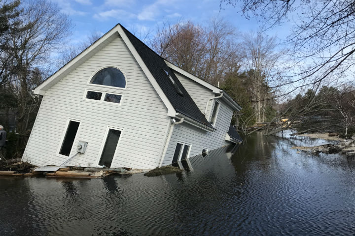 A house on Beaumont Farm Road in Bracebridge, Ont., sinks on Tuesday morning.