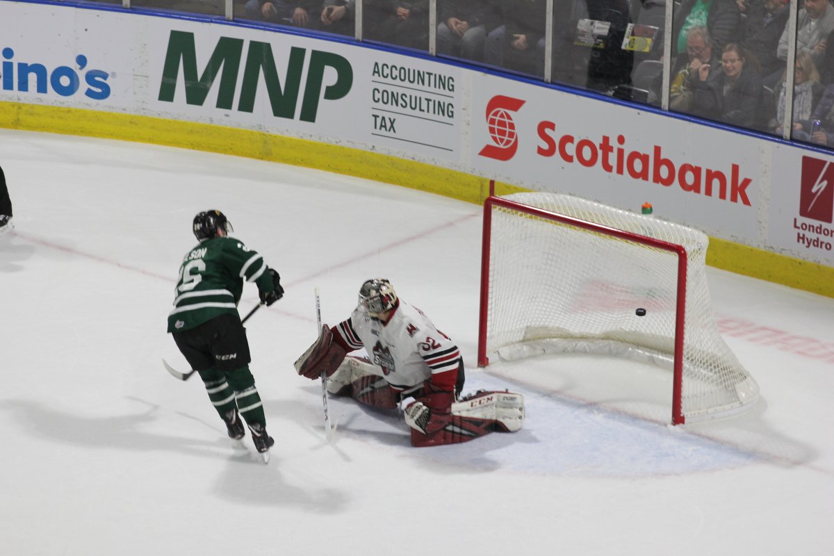 Josh Nelson of the London Knights scores on a penalty shot against Anthony Popovich of the Guelph Storm.
