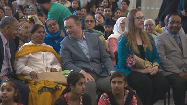 UCP Leader Jason Kenney talks to a woman at Meadows Community Recreation Centre in Edmonton on Sunday.