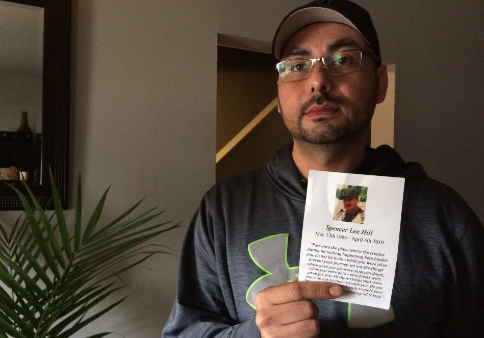 Jeffrey Hill holds a memorial card from his brother's funeral. He says Spencer Lee Hill died from an overdose on April 4th in downtown London. 