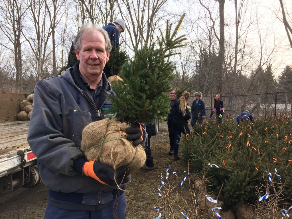 Upper Thames River Conservation Authority Forester, John Enright, holds one of the trees that'll be planted as part of a spring blitz. \.