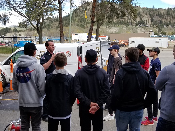 Students listen to a fire hall instructor on Wednesday.