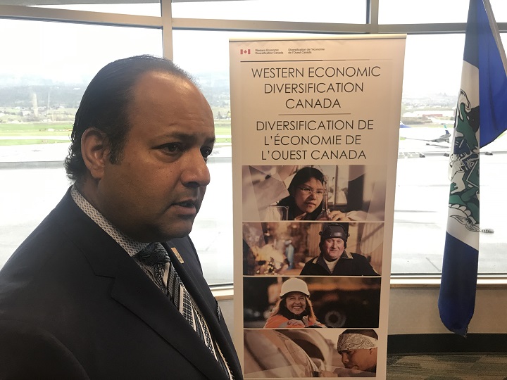 Kelowna International Airport manager Sam Samaddar discusses possible flight connections with the media during Thursday’s federal funding announcement at YLW.