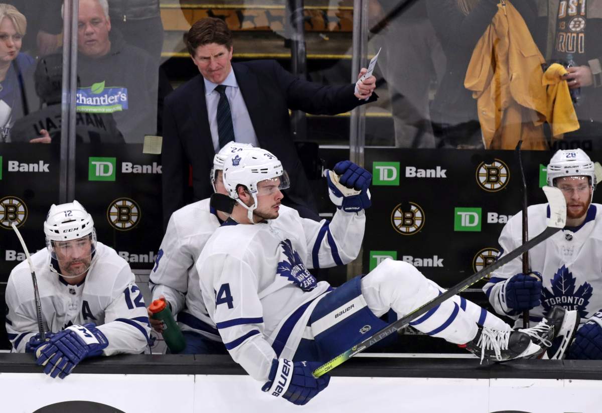 Toronto Maple Leafs center Auston Matthews (34) sits on the boards as head coach Mike Babcock gestures to his players on ice during the final seconds of the third period against the Boston Bruins in Game 7 of an NHL hockey first-round playoff series, Tuesday, April 23, 2019, in Boston. The Bruins won 5-1, eliminating the Leafs.