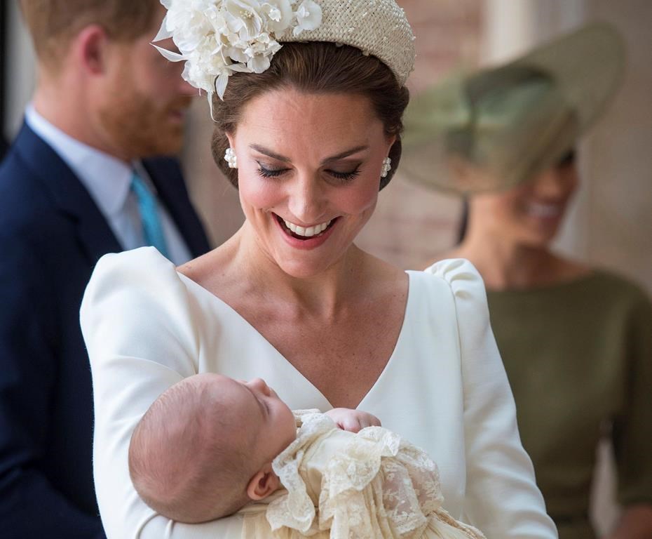 FILE - In this Monday, July 9, 2018 file photo, Kate, Duchess of Cambridge carries Prince Louis as they arrive for his christening service at the Chapel Royal, St James's Palace, London. The youngest child of Prince William and his wife Kate is about to celebrate his first birthday. Prince Louis will mark the milestone Tuesday, April 23, 2019.