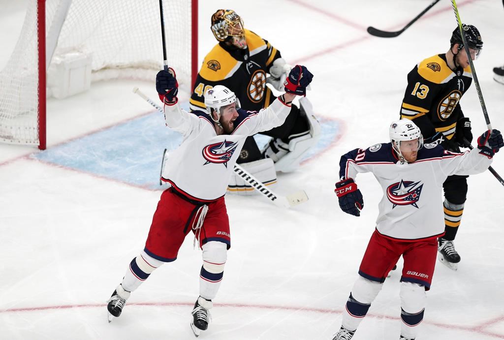 Columbus Blue Jackets center Riley Nash, right, celebrates with Brandon Dubinsky, left, after his goal off Boston Bruins goaltender Tuukka Rask during the third period of Game 1 of an NHL hockey second-round playoff series, Thursday, April 25, 2019, in Boston. Behind Nash is Boston Bruins center Charlie Coyle (13). (AP Photo/Charles Krupa).