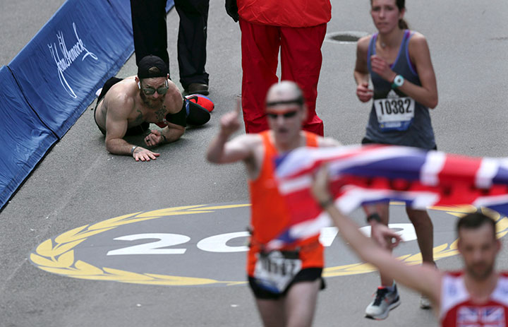 Micah Herndon, a former Marine from Ohio, crawls down Boylston Street towards the finish line of the 123rd Boston Marathon on April 15, 2019.