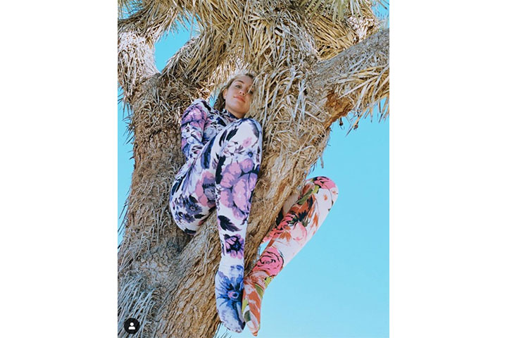 Miley Cyrus posted photos herself on social media sitting on a famed California Joshua tree.
