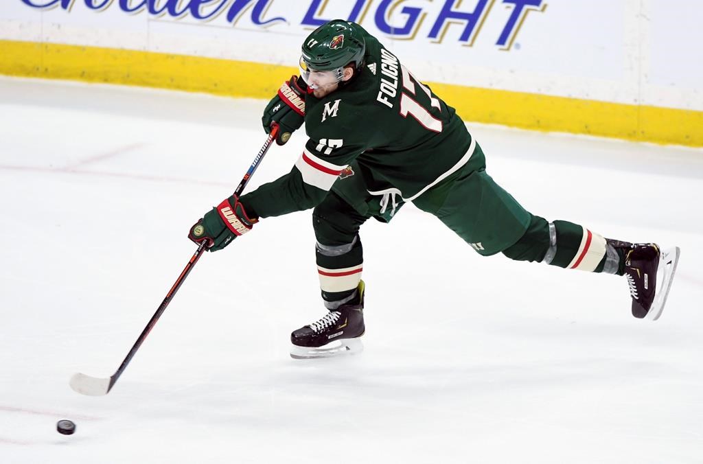 Minnesota Wild's Marcus Foligno (17) shoots the puck against the Winnipeg Jets during the third period of an NHL hockey game, Tuesday, April 2, 2019, in St. Paul, Minn. Foligno scored a goal on the play. The Wild won 5-1. (AP Photo/Hannah Foslien).