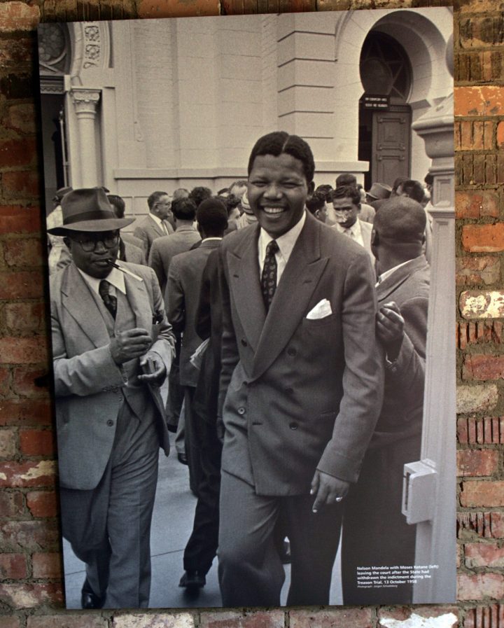 A picture taken by Jurgen Schadeberg on Oct. 13, 1958, shows Nelson Mandela, right, and Moses Kotane, left, leaving the court after prosecutors withdrew an indictment for treason. The photo was hanging in Rivonia, South Africa on June 19, 2008.