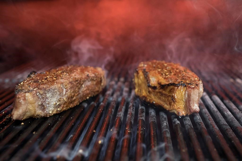 This Nov. 27, 2018, file photo shows steaks on a grill at a restaurant in New York.