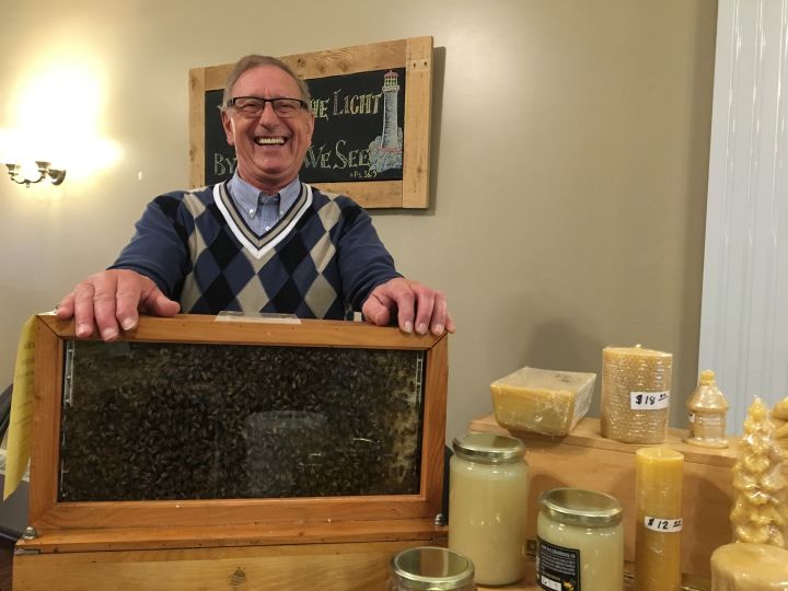 Honey producer Bert Blouin with his portable hive at the new Calgary Urban Market .