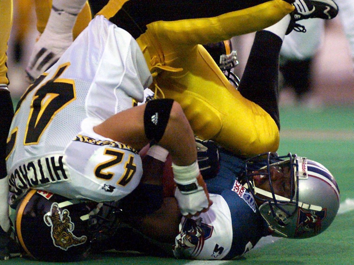 Hamilton Tiger-Cats linebacker Rob Hitchcock tackles Montreal Alouettes running back Thomas Haskins during first quarter CFL action in Montreal Thursday, August 12, 1999.