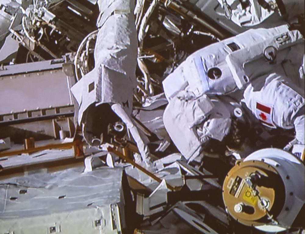 Canadian astronaut David Saint-Jacques takes part in a spacewalk as seen in the livefeed from the Canadian Space Agency headquarters Monday, April 8, 2019 in St. Hubert, Que.