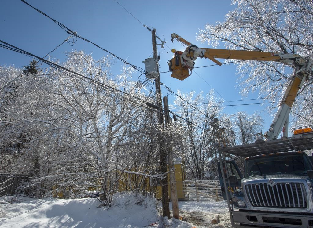 Hydro Quebec workers repair power lines in Laval, Que., Wednesday, April 10, 2019 after an ice storm hit the area.
