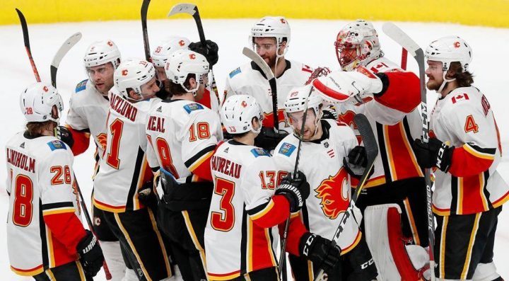 Calgary Flames goaltender Mike Smith (41) celebrates 5-3 win against the San Jose Sharks with teammates in the third period of an NHL hockey game in San Jose, Calif., Sunday, March 31, 2019. (AP Photo/Josie Lepe).