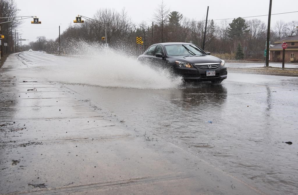 Streets and sidewalks are flooded from heavy rain on Foresthill Road in Fredericton, N.B. on Saturday, April 20, 2019.