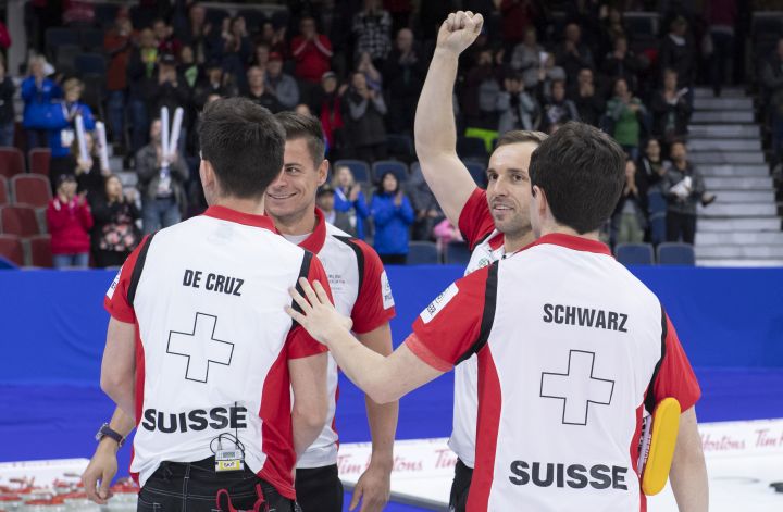 Switzerland skip Peter de Cruz, lead Valentin Tanner, second Sven Michel and fourth Benoit Schwarz, left to right celebrate their victory over Japan in the bronze medal game at the Men's World Curling Championship in Lethbridge, Alta. on Sunday, April 7, 2019. 