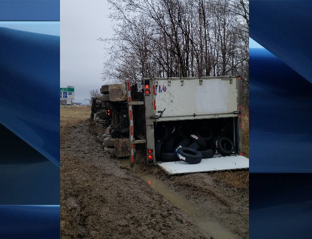 An allegedly stolen transport truck lays in the north ditch of Highway 401 on Sunday.