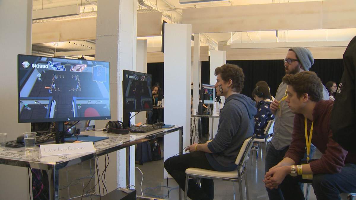 A university game developer tests out Escape Artist at the Ubisoft Game Lab Competition.