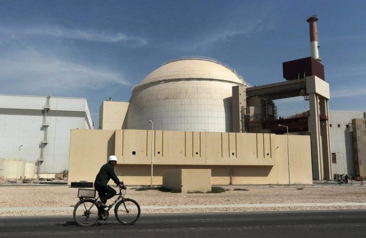 In this Oct. 26, 2010 file photo, a worker rides a bicycle in front of the reactor building of the Bushehr nuclear power plant, just outside the southern city of Bushehr. 