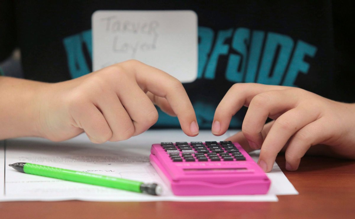 File photo. A student doing math with a calculator.