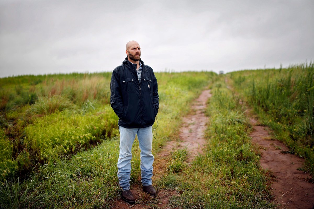 In this July 17, 2014, file photo, Michael Behenna stands on land that he helps work in Medford, Okla. 