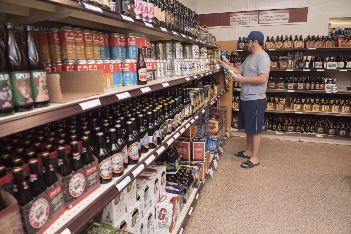 File - Customer Matt Oliver shops in the craft beer section of the NB Liquor store attached to the old Fredericton Railway Station in Fredericton, N.B., on Friday, June 16, 2017.
