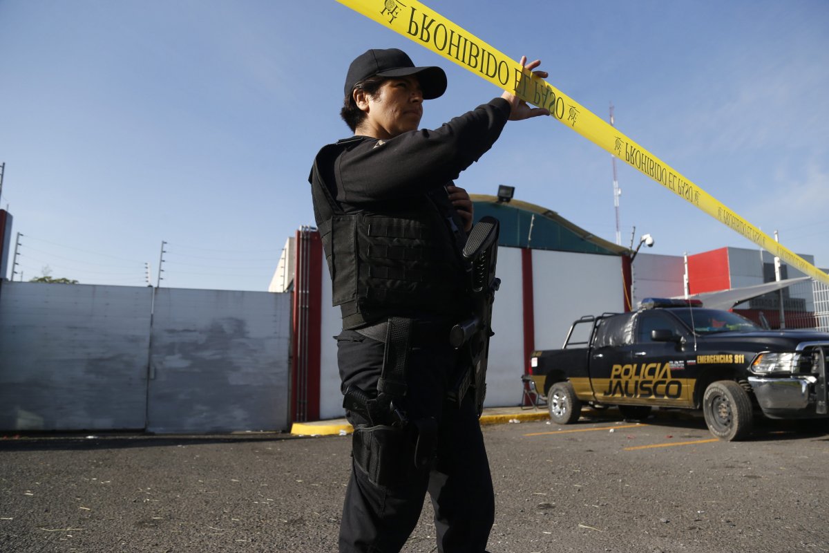 A police agent stands on guard outside of the Forensic Sciences Institute facilities in Guadalajara, Jalisco state, Mexico in a September 20, 2018, file photo. Authorities say 35 bodies were found buried near the city.
