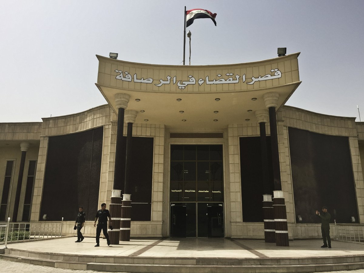 FILE - in this May 23, 2018 file photo, security guards stand outside the building where Islamic State militants are tried in a special counterterrorism court in Baghdad, Iraq. A Baghdad court sentenced to death three French citizens Sunday for being members of the Islamic State group, an Iraqi judicial official said. The official said the three were among 12 French citizens handed over to Iraq in January by the U.S.-backed Syrian Democratic Forces. Then SDF has handed over to Iraq hundreds of suspected IS members in recent months. 