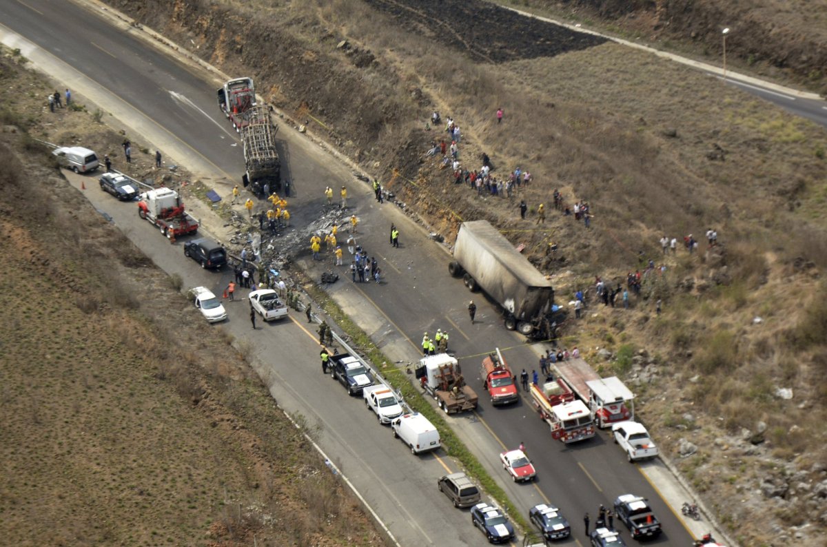 In the photo provided by the Civil Protection Office of Veracruz, rescue personnel work in the recovery efforts at a deadly road accident between a bus and a semi-trailer, on a mountain road in Veracruz state, Mexico, Wednesday, May 29, 2019. 