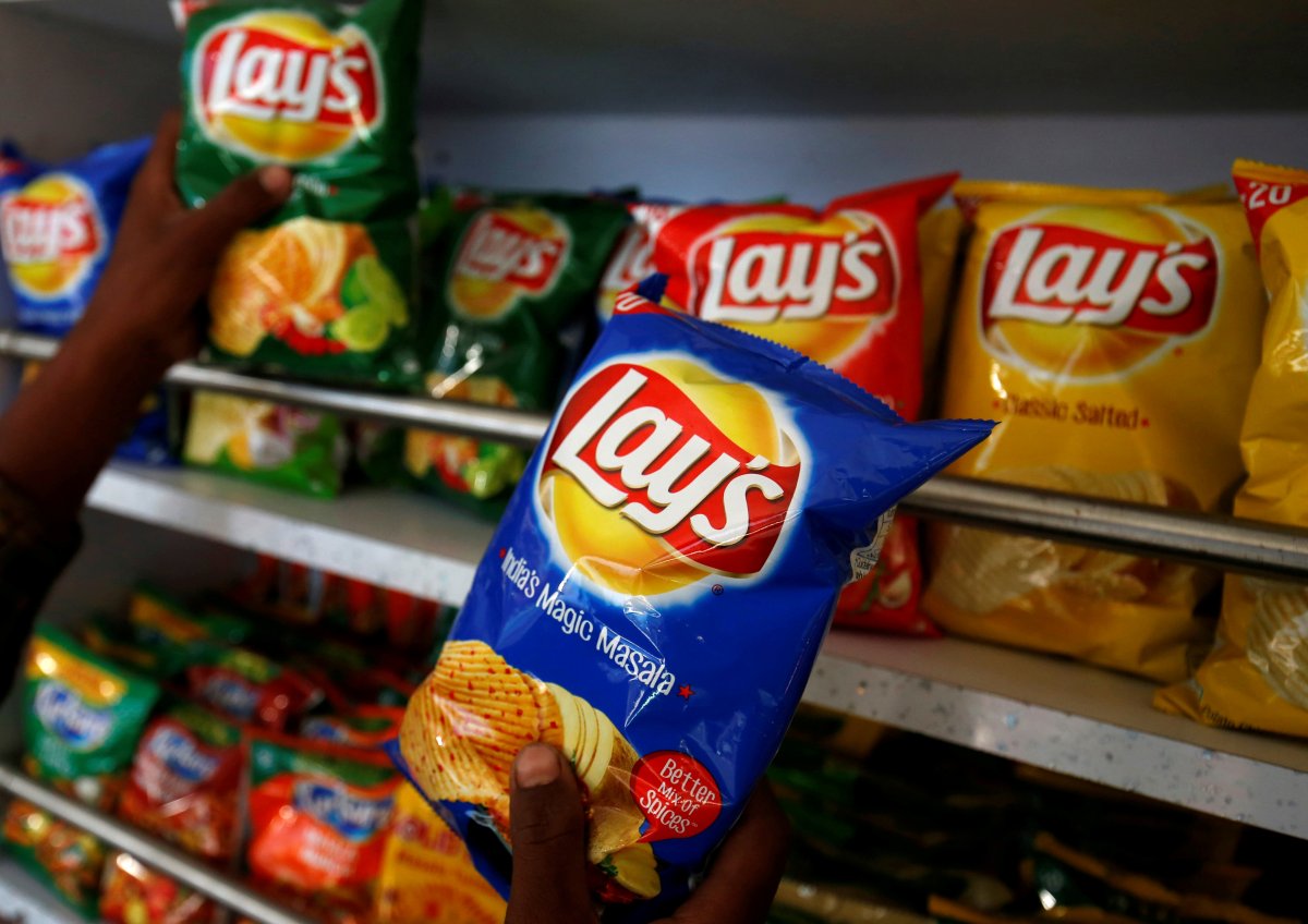 A customer picks packets of Lay's potato chips at a shop in Ahmedabad, India, April 26, 2019. 