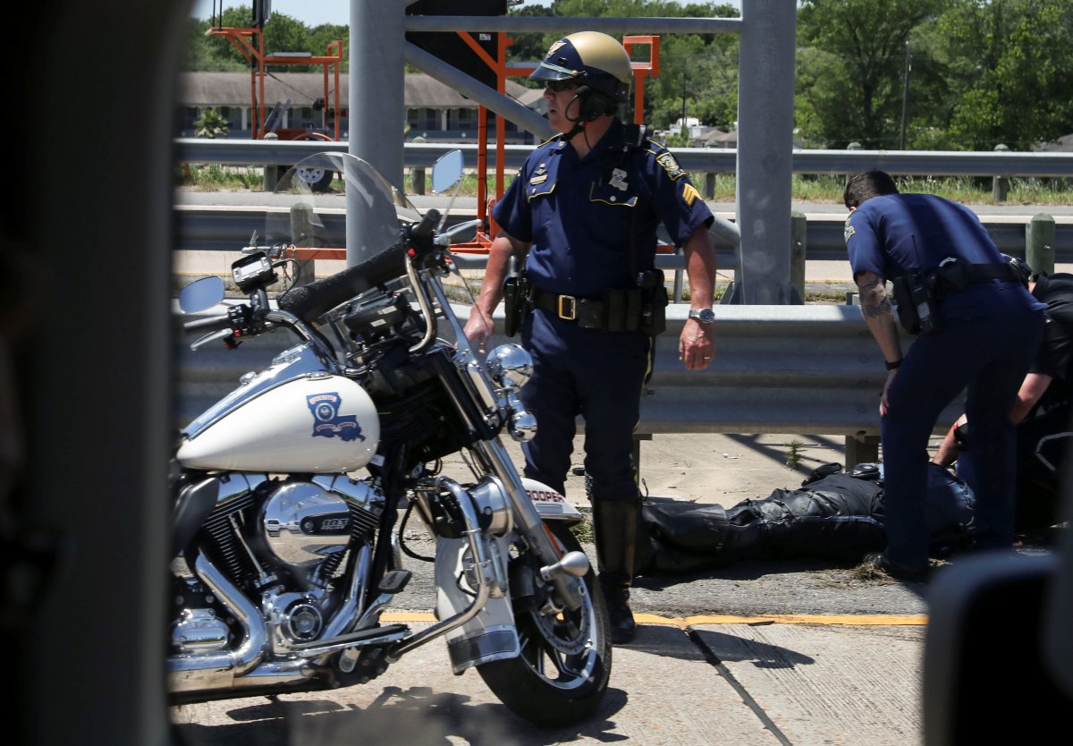 Police officers tend to a fallen colleague after a police motorcycle accident during U.S. President Donald Trump's motorcade in Lake Charles, Louisiana, U.S., May 14, 2019. 