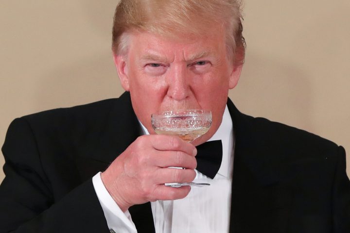 U.S. President Donald Trump drinks during a state banquet at the Imperial Palace in Tokyo, Japan, May 27, 2019. 