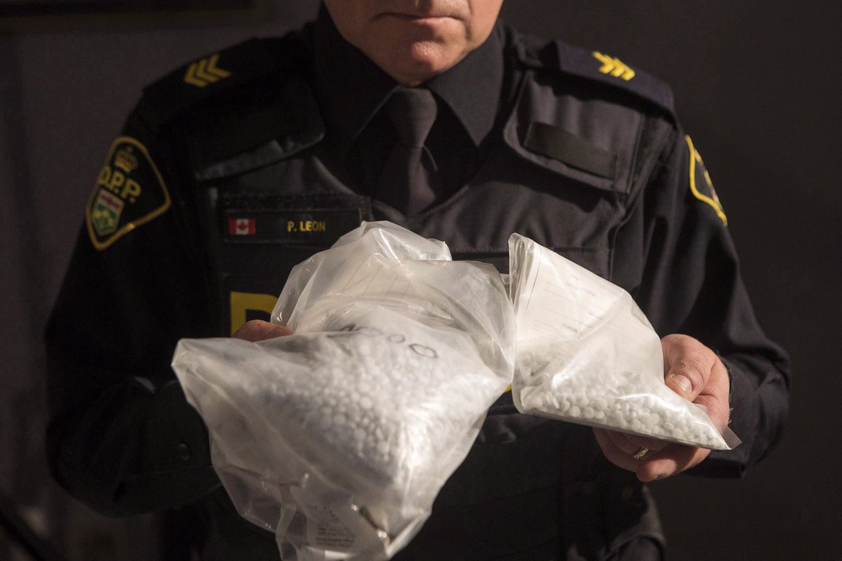 An OPP officer displays bags containing fentanyl as Ontario Provincial Police host a news conference in Vaughan, Ont., on February 23, 2017.