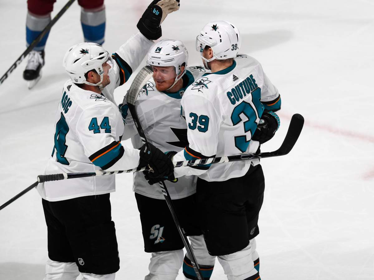 San Jose Sharks defenseman Marc-Edouard Vlasic, left, celebrates with center Gustav Nyquist and center Logan Couture, right, after his goal against the Colorado Avalanche during the third period of Game 3 of an NHL hockey second-round playoff series Tuesday, April 30, 2019, in Denver. The Sharks won 4-2. (AP Photo/David Zalubowski)