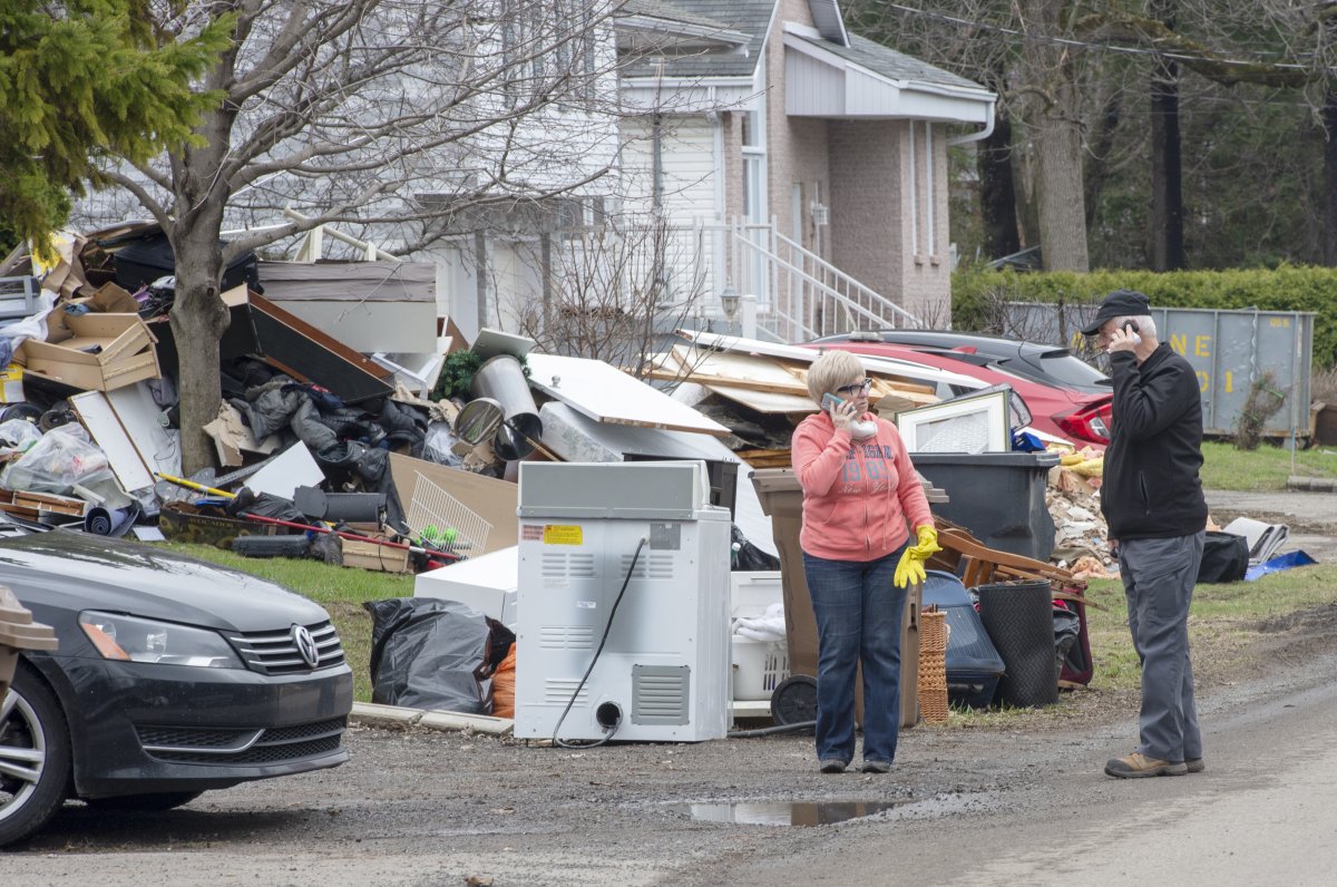 Residents clean up after the flood waters recede in certain sectors of Ste-Marthe-sur-le-Lac, Que. 