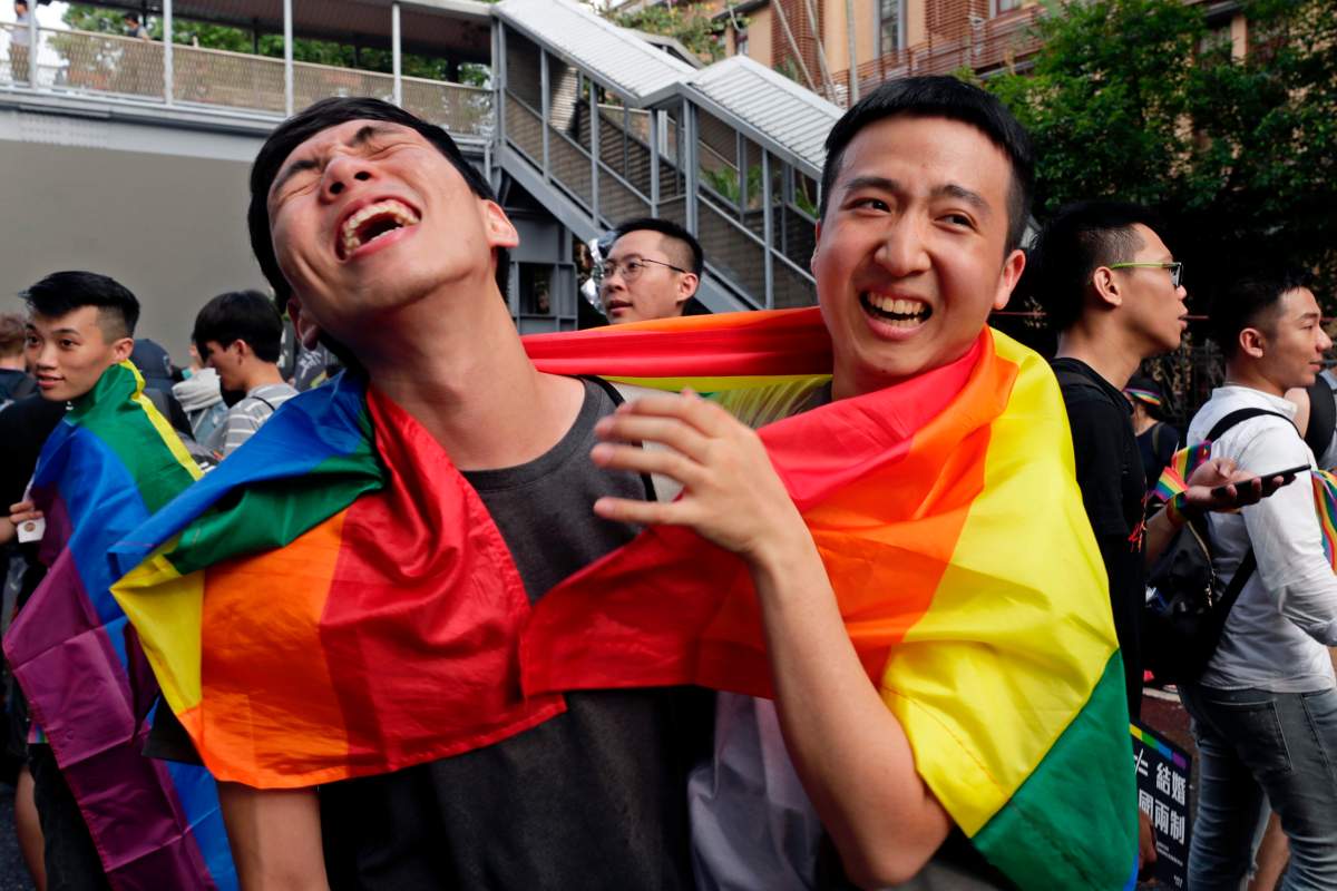 Supporters of same-sex marriage celebrate as they gather outside the parliament building as a bill for marriage equality is debated by parliamentarians in Taipei, Taiwan, 17 May 2019.