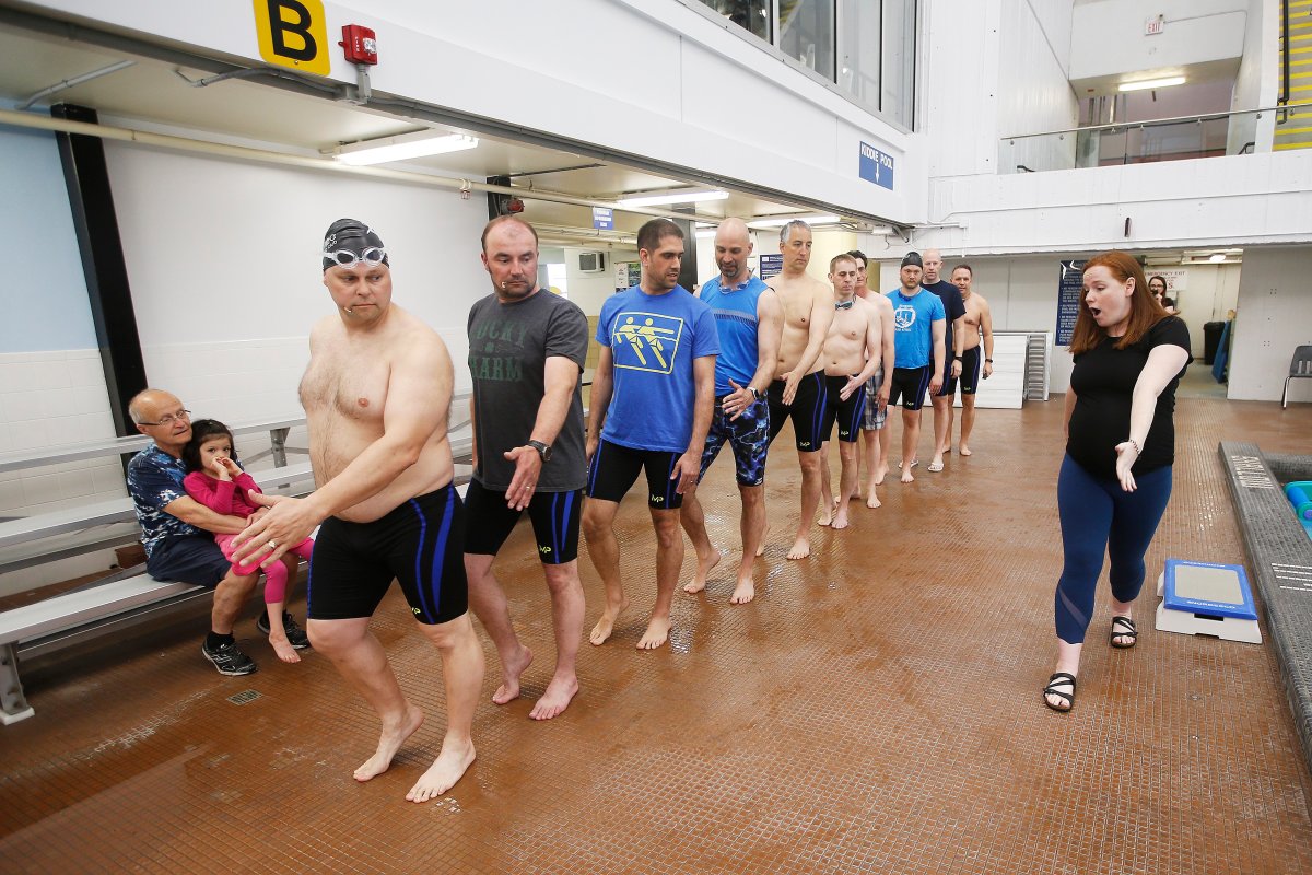 Fathers of members of the Aquatica Synchro Club practice their routine with the assistance of head coach Holly Hjartarson at the Pan Am Pool in Winnipeg Saturday, May 18, 2019. The fathers decided to come together and form the group in support of their daughters' synchro club.