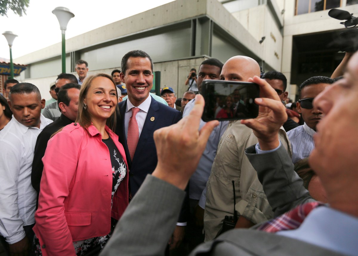 Venezuela's opposition leader and self-proclaimed interim president Juan Guaido, center, poses for a selfie photo with supporters after a meeting of "Plan Pais" or Country Plan at University Catholic Andres Bello in Caracas, Venezuela, Friday, May 24, 2019.
