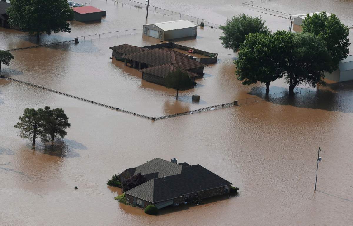 Homes are flooded on the Arkansas River in Tulsa, Okla., on Friday, May 24, 2019.