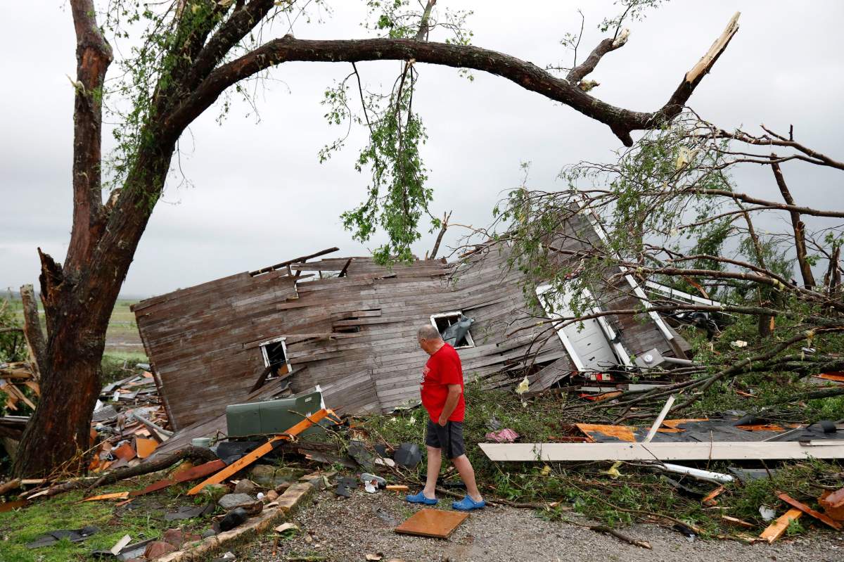 Joe Armison looks over his destroyed barn after a tornado struck the outskirts of Eudora, Kan., Tuesday, May 28, 2019.
