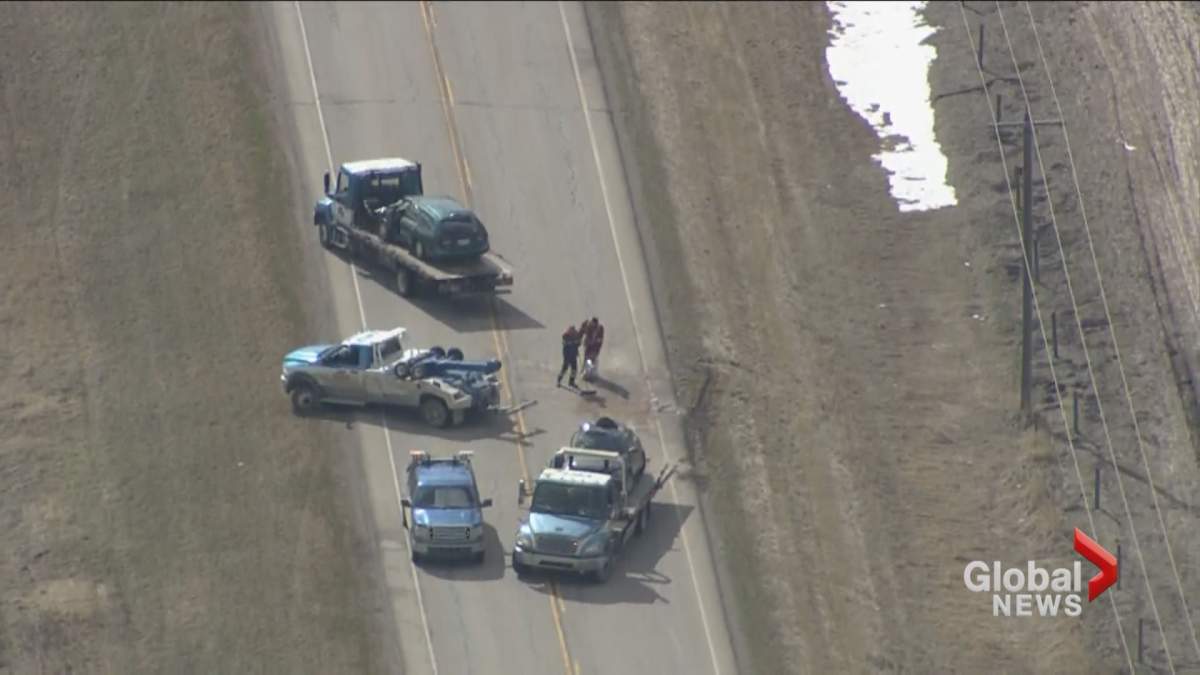 Global1 helicopter footage shows vehicles being loaded onto tow trucks at the scene of a fatal collision near Airdrie on Wednesday, May 8.