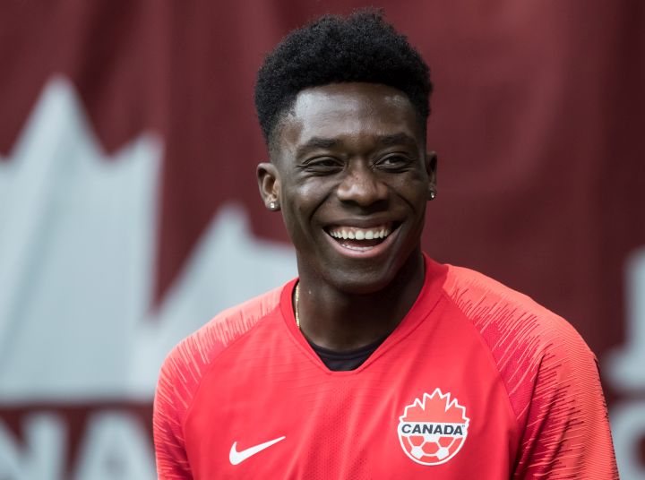 Canada's Alphonso Davies, who isn't playing due to an injury, watches as his teammates warm up before a CONCACAF Nations League qualifying soccer match against French Guiana in Vancouver, on Sunday March 24, 2019. 