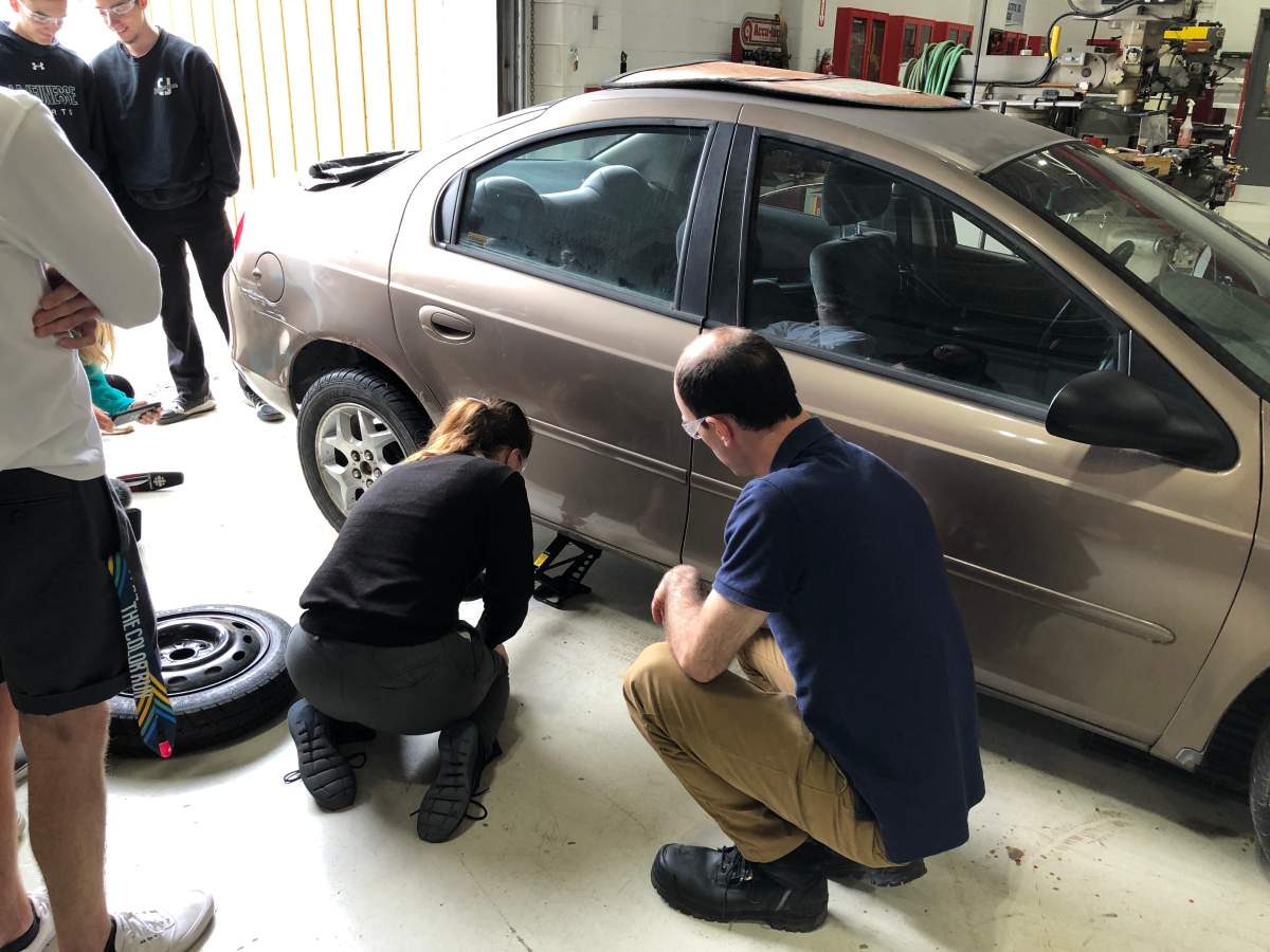 A student participates in the auto maintenance workshop, as part of adulting courses at E.J. Lajeunesse catholic high school.